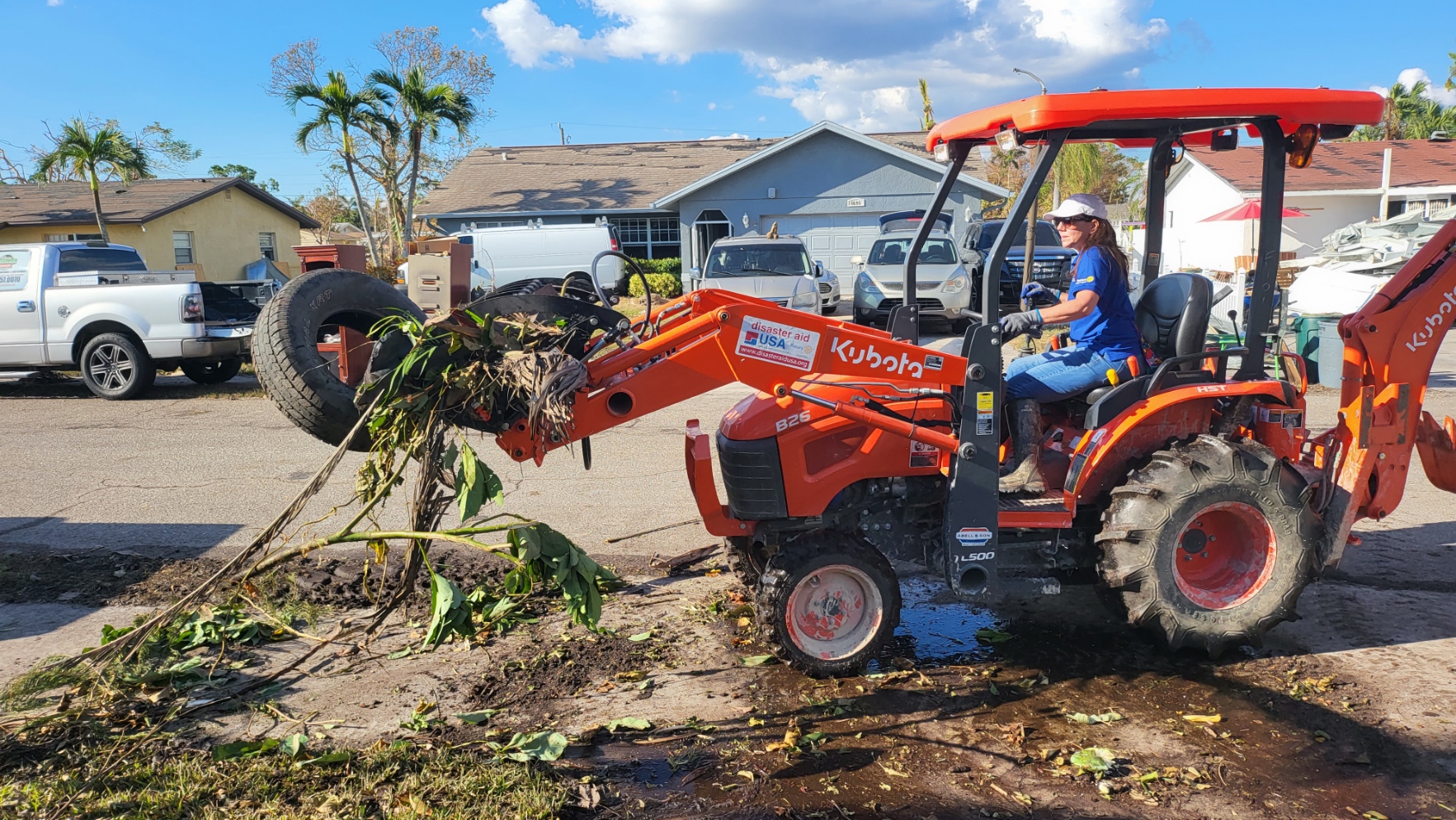 A Rotary volunteer operating heavy equipment during disaster cleanup